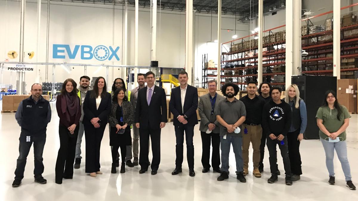 Above: Congressman Schneider visits with leaders of EVBox, a local electric vehicle supply equipment company, to discuss federal EV funding