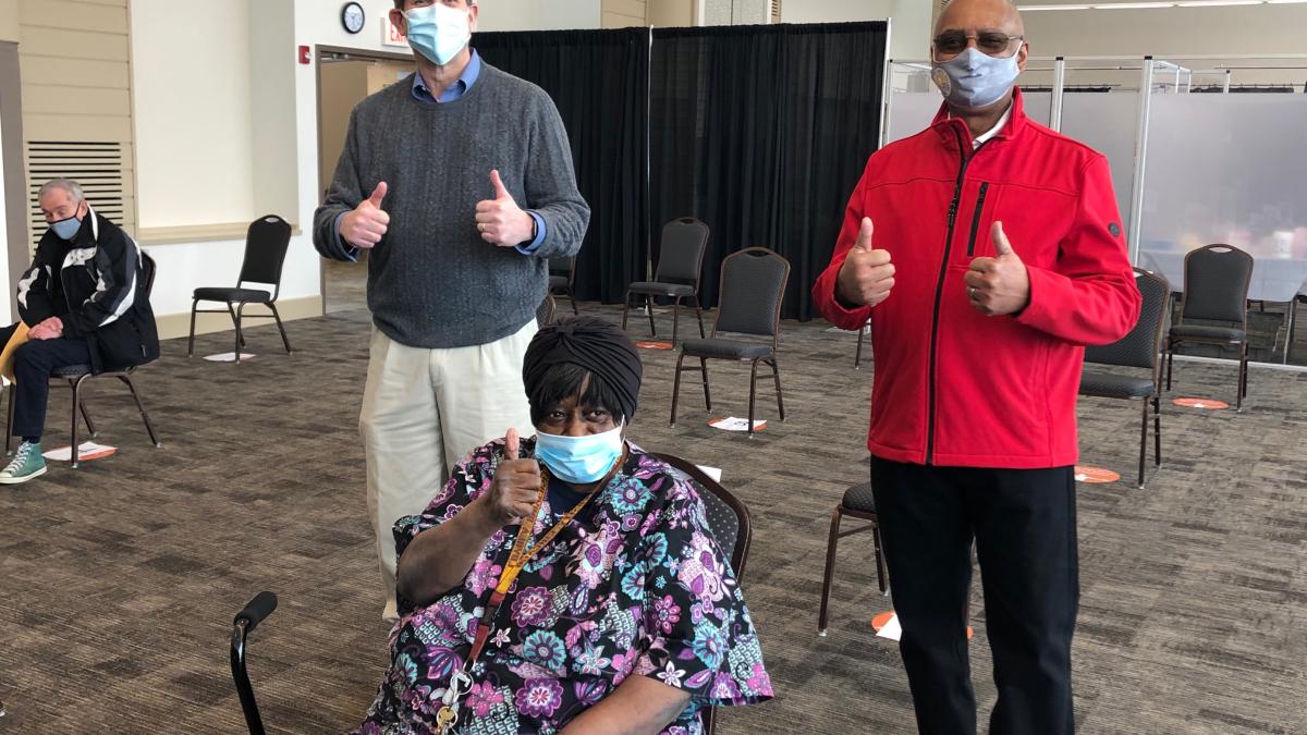 Congressman Schneider and Mayor Leon Rockingham celebrate “Ms. Bee” receiving her COVID vaccine dose