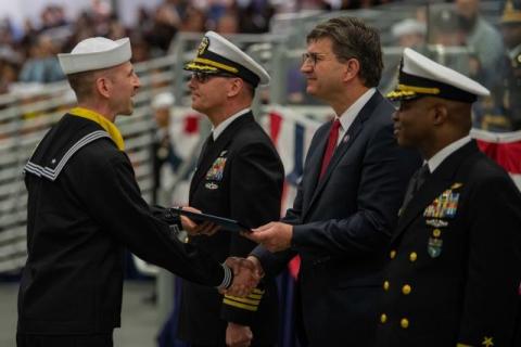 Brad shaking hands with servicemember.