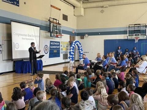 Brad speaking at school assembly.