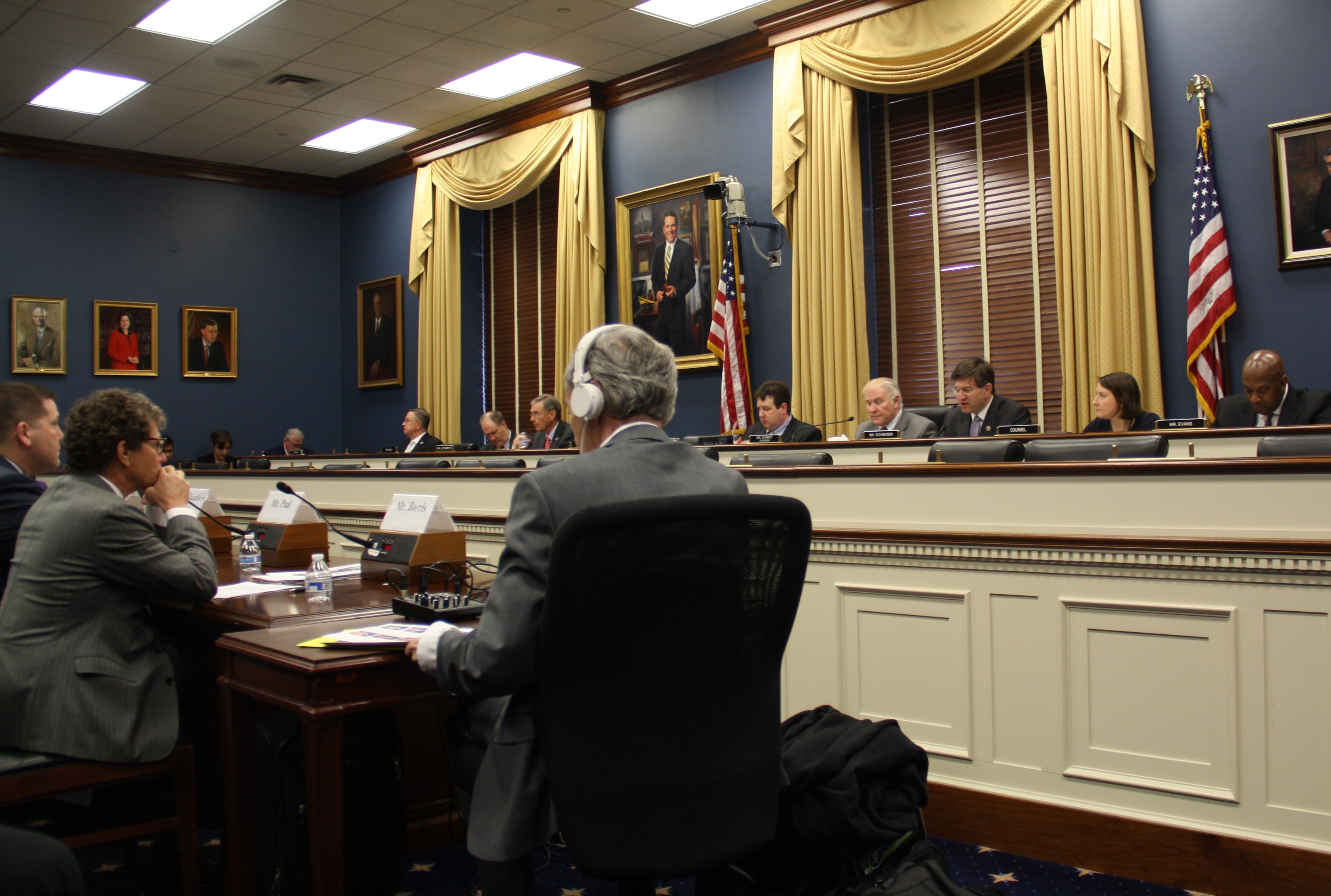Rep. Schneider on panel at a meeting