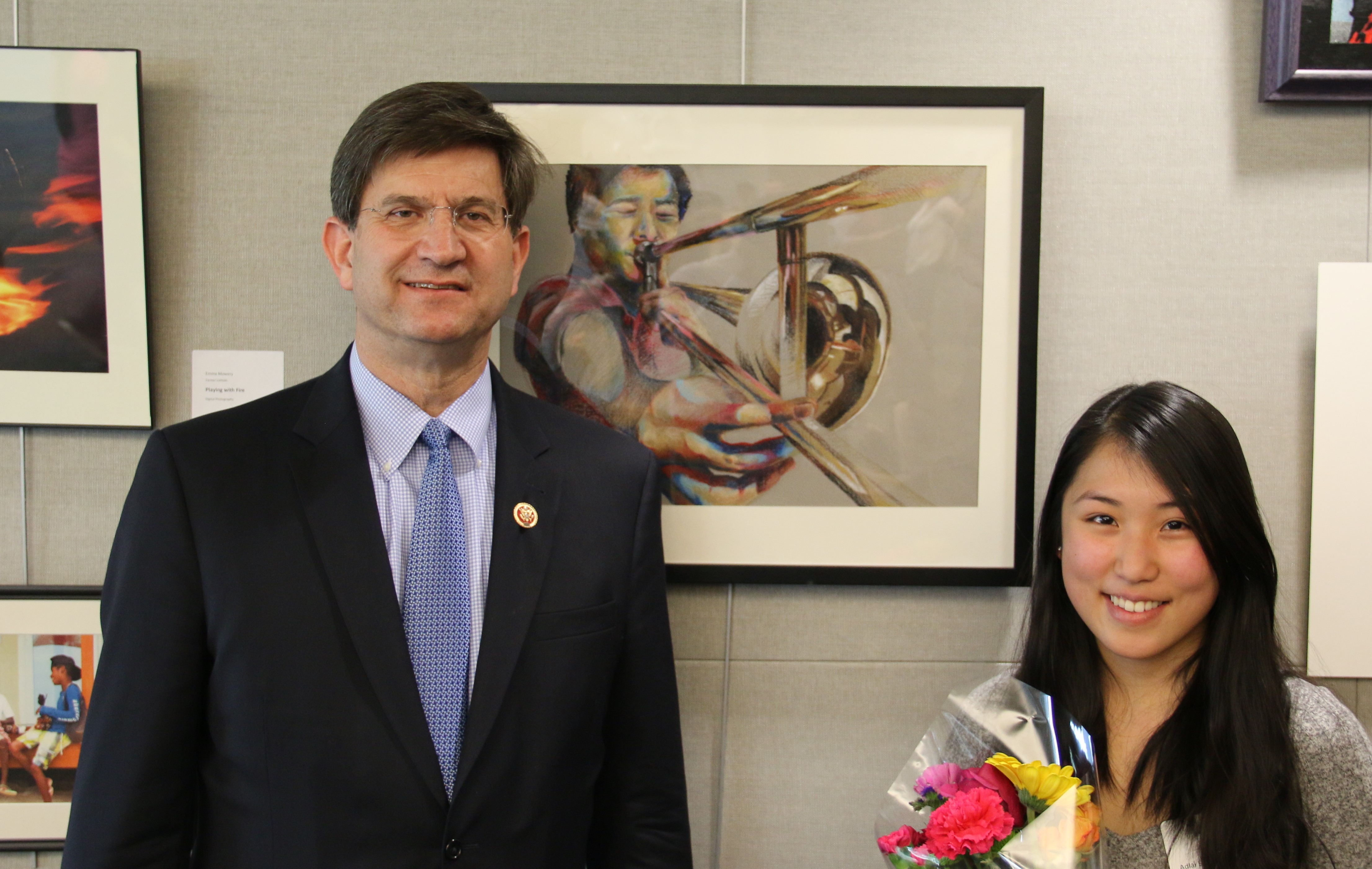Rep. Schneider taking a picture with artist