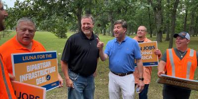 Below: Schneider jokes with constituents from Laborer’s International Union of North America Local 152, who came to support the bipartisan infrastructure deal